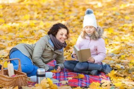 Mother and daughter reading at the park