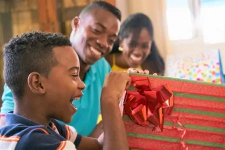 13 year old boy opening birthday gift