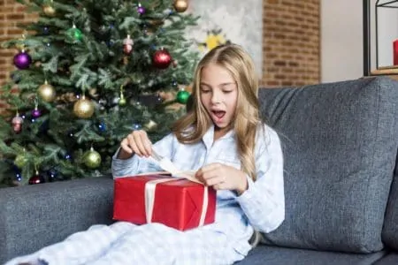 Teenager opening a Christmas present