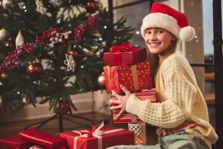 15 year old girl excited to open her christmas gift