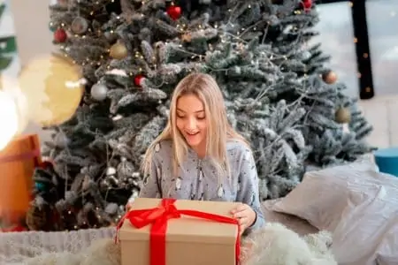 Happy 17 year old girl excited to open her christmas gift