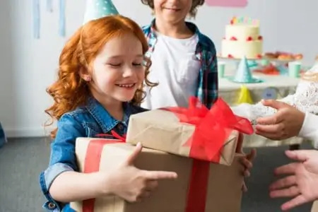 Nine year old little girl receiving a birthday gift