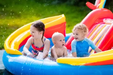 Kids playing in an inflatable water slide