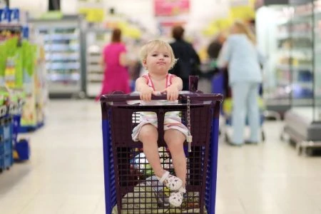 Baby sitting in shopping cart