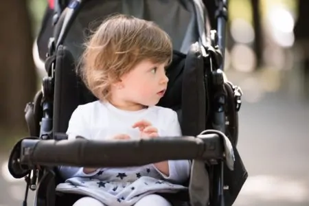 Toddler girl sitting in a stroller