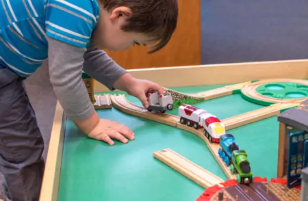 Young boy playing with the best train table