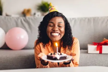 Aunt blowing candles on a cake celebrating birthday