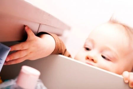 Child putting a hand inside a drawer