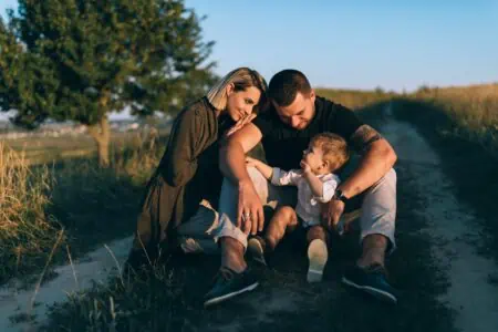 Lovely couple with their first born child sitting together