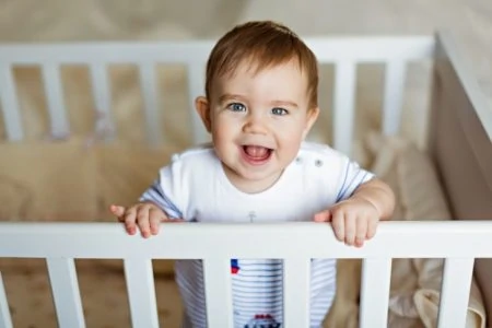 Toddler trying to escape his crib