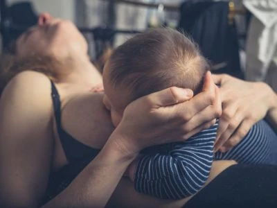 Mother with mastitis breastfeeding her baby