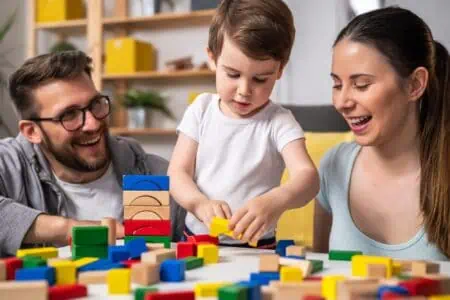 Parents playing memory games with their son.