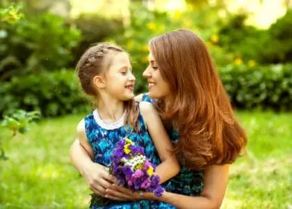 A mother and her little daughter playing in the park