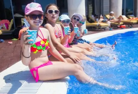 Children having fun on the side of the pool