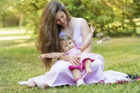 Beautiful mom and baby daughter in matching dresses