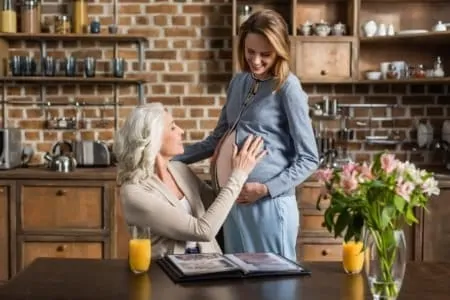 Pregnant woman her baby news with her mother