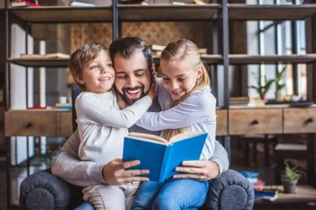 Daughter reading to his two daughters