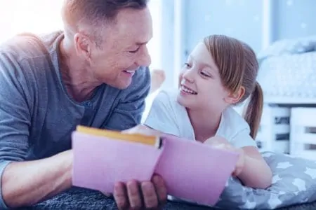 Dad reading poems to his daughter