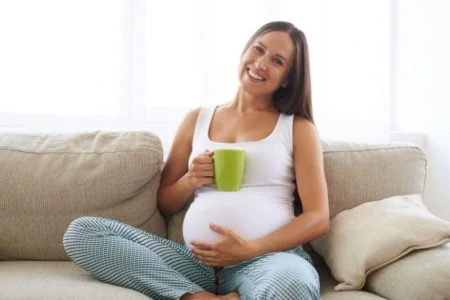 Pregnant woman drinking a cup of tea