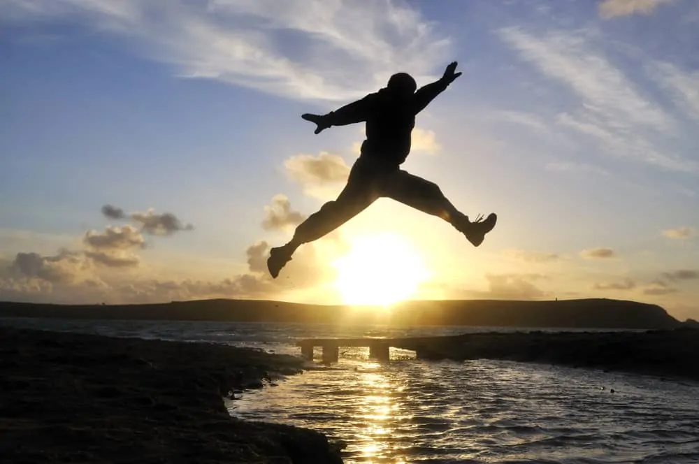 man jumping over water