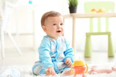 Cute baby boy with sippy cup