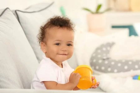 Baby drinking from a sippy cup