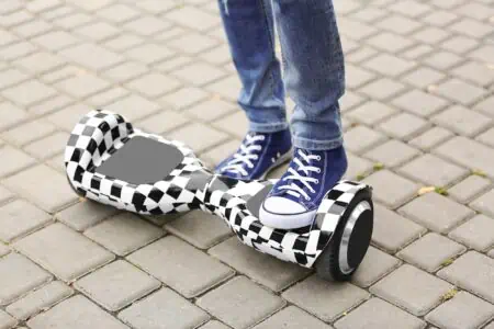 Teenager boy using hoverboard in park