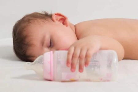 Baby holding a bottle